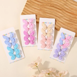 Detail of 16 piece colorful butterfly hair clips with glitter tulle and rhinestone accents