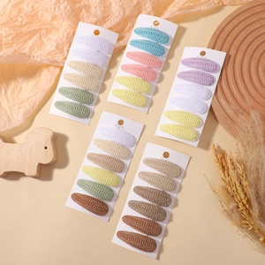 Knitted teardrop hair clips set for girls in various candy colors on a wooden tray