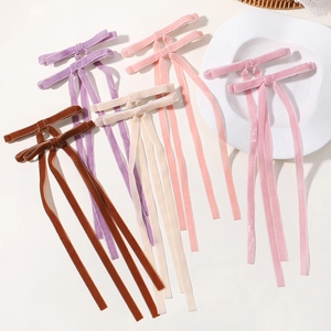 Detailed close-up of velvet long ribbon bow hair clips in multiple macaron colors