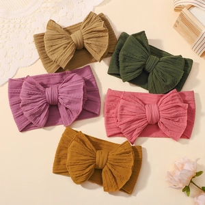 Five pack of elastic baby headbands with large textured bows in various sweet colors