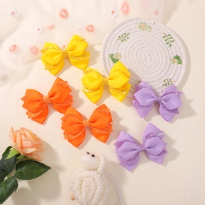 Set of 6 handmade glitter bow hair clips in yellow, orange, and purple for girls