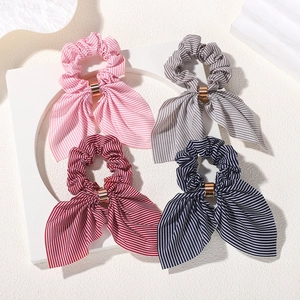 Set of four striped bow hair scrunchies with elegant gold metal buckles in various colors