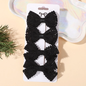 Set di 4 eleganti fermagli per capelli con fiocco in pizzo nero su cartoncino bianco