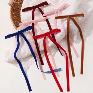 Elegant velvet bow hair clip with long ribbon streamers in various vintage colors