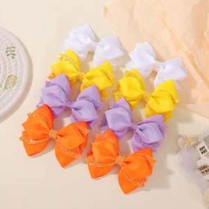 Detail of 8-piece bow hair clip set with glitter and grosgrain fabric layers