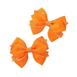 Sparkly orange glitter ribbon bow hair clips for girls set of two on white background