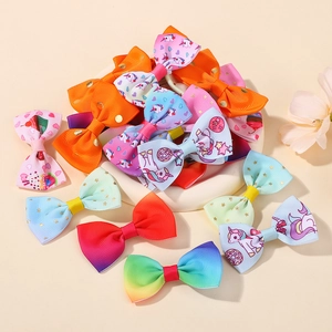 Detailed macro view of colorful grosgrain ribbon bows with unicorn and gradient patterns