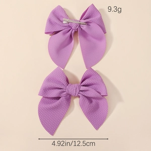Pair of purple waffle fabric bow hair clips for girls with size and weight specs