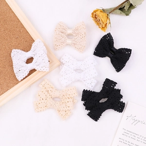 Lace bow hair clip set for girls in white, beige, and black with floral background