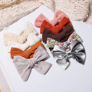 Detail shot of assorted fabric and lace bow hair clips in various colors and textures