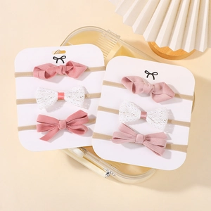 Detailed view of soft nylon baby headbands with pink fabric and white lace bows