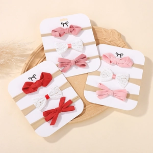 Detail of infant nylon headbands with delicate lace and soft bows for baby girls