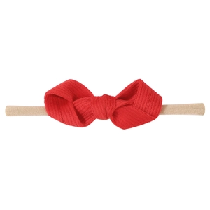 Infant nylon headband featuring a large red ribbed bow with soft elastic band