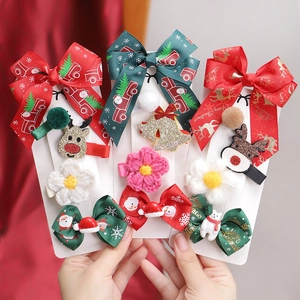 Detailed view of Christmas hair clips set with ribbon bows and reindeer ornaments