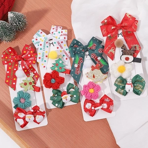 Detail of Christmas hair clip set with velvet bows, knitted flowers and festive characters
