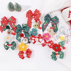 Festive Christmas hair clips set with Santa, reindeer and bows for girls on a card