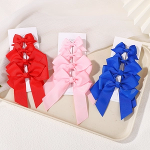 Detailed set of three colorful ribbed grosgrain ribbon bow hair clips on display card