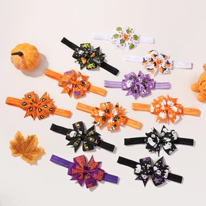 Flat lay of 12 Halloween baby headbands featuring pumpkins and ghost bow patterns
