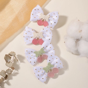 Lot de quatre barrettes nœuds en tulle blanc avec pois dorés et broderie cerise