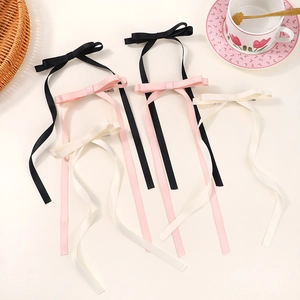 Elegant satin bow hair clips with long tassels in black, pink and cream colors