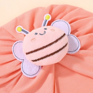 Close-up of baby cotton hat featuring a cute plush honeybee with soft embroidery detail