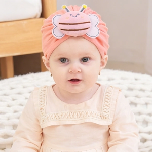 Pink cotton baby turban hat with a cute 3D plush bee decoration for infants
