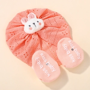 Detail of coral lace baby hat and non-slip socks with plush rabbit decoration