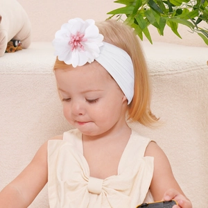 Baby headband with large white 3D flower decoration for infants on a toddler model