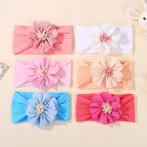 Flat lay of 6-piece baby floral headbands in pink, white, orange, and blue colors