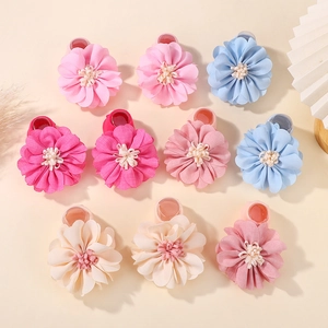 Flat lay of colorful chiffon petal hair ties with soft floral textures and elastic bands