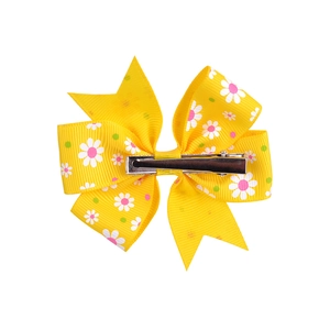 Yellow grosgrain ribbon hair bow clip for girls featuring white daisy floral patterns