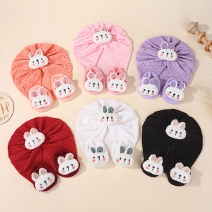 Detail of baby turban hat and socks set with 3D plush bunny in six vibrant colors