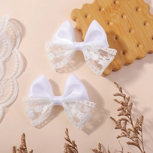 Pair of white lace and satin bow hair clips for girls in a sweet lolita style
