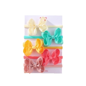 5-piece baby bow headband set with elastic ribbons in pastel colors on display card