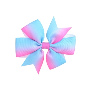 Detail view of multi-layered grosgrain ribbon hair bow with pink and blue gradient effect
