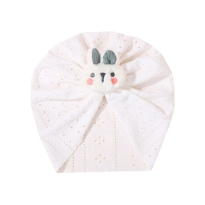 White infant turban hat with hollow lace pattern and cute plush bunny ear decoration