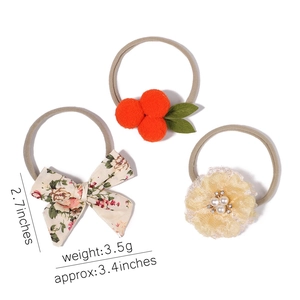 Detailed view of handmade baby headbands with floral bows and dimensions in inches