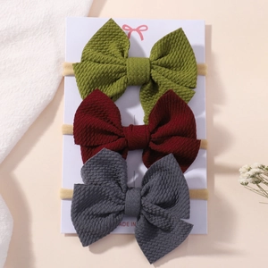 Three-piece set of textured bubble fabric bow headbands for baby girls in three colors