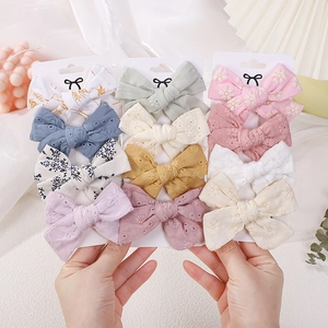 12-piece colorful cotton bow hair clips set for girls featuring embroidery and floral patterns