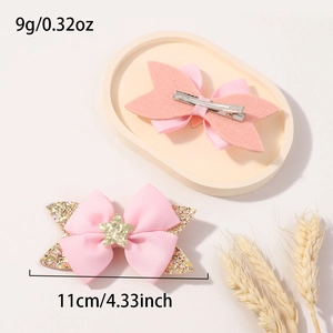 Detail of pink bow hair clip with gold star and sequins showing 11cm width dimensions
