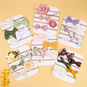 Detailed set of handmade bow headbands for babies in assorted colors on display cards