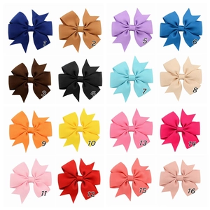 Selection of 16 colorful grosgrain ribbon hair bows with fishtail ends in a grid layout