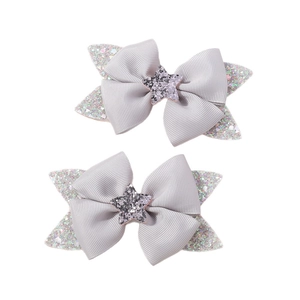 Pair of cute silver bow hair clips with glitter star and polka dot patterns for girls
