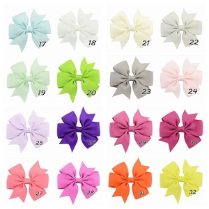 Detailed grid view of 16 multicolor grosgrain ribbon fishtail bows for kids with SKU numbers