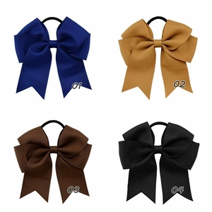 Detail showing 4.5 inch grosgrain ribbon hair ties in blue, yellow, brown, and black