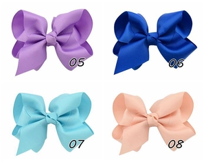 Detail view of large grosgrain ribbon hair bows in purple, blue, light blue, and pink