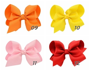 Detail showing colorful grosgrain ribbon hair bows in orange, yellow, pink and red