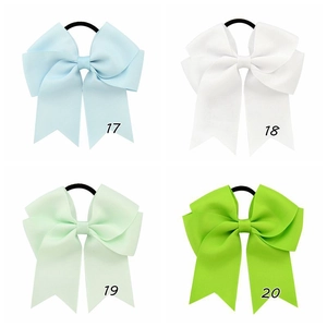 Detailed view of four grosgrain ribbon hair bows in blue, white, mint and green colors