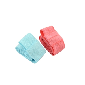 Detail view of 1.5cm elastic fabric headbands in light blue and coral pink colors