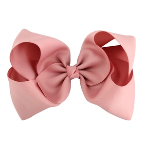 Detail of soft pink 8-inch grosgrain ribbon bow hair clip with layered 3D structure